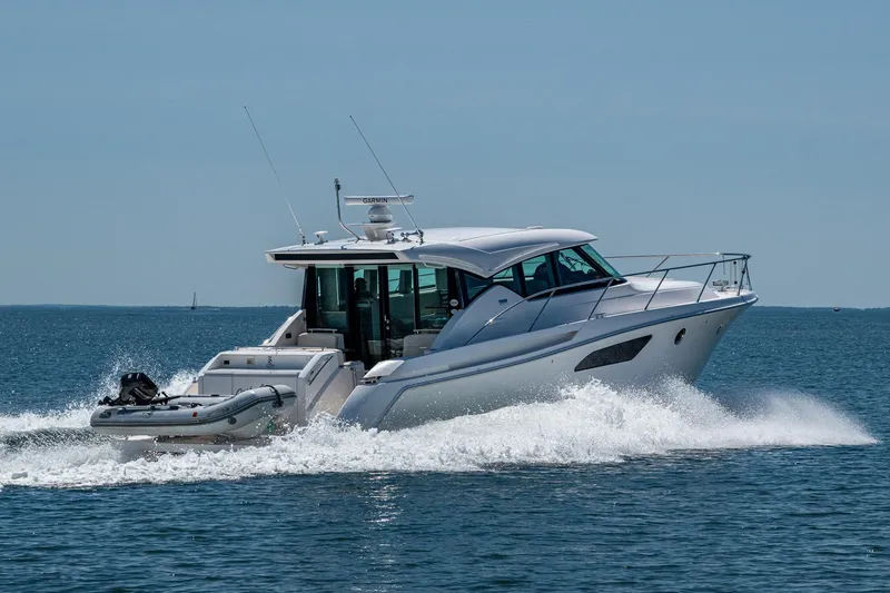 Slide: The Image of 2020 Tiara Yachts C44 Coupe cruising on open water, side view. - 88