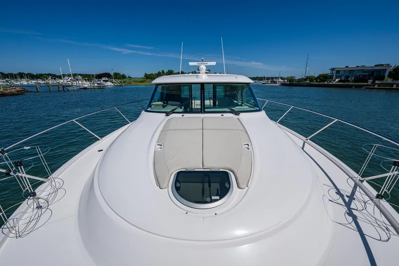 Slide: The Image of 2020 Tiara Yachts C44 Coupe on water, showcasing sleek design and spacious deck. - 9