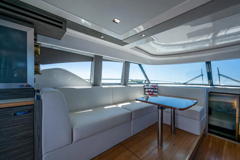 Slide: The Image of Luxurious interior of 2020 Tiara Yachts C44 Coupe with elegant seating and panoramic windows. - 95