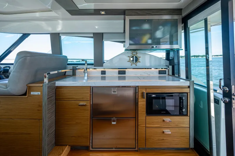 Slide: The Image of Luxurious interior of 2020 Tiara Yachts C44 Coupe with modern kitchen amenities. - 96