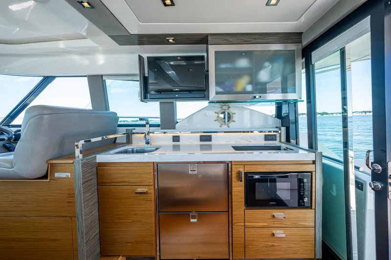 Slide: The Image of 2020 Tiara Yachts C44 Coupe interior with modern kitchen and ocean view. - 97