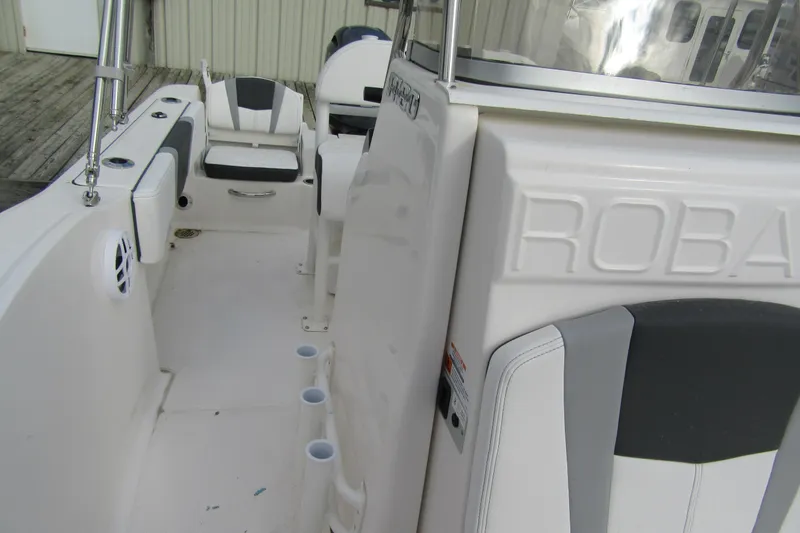 Slide: The Image of 2026 Robalo R180 Center Console boat interior with seating and storage. - 11
