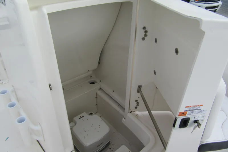 Slide: The Image of 2026 Robalo R180 Center Console boat interior storage compartment with white finish. - 12