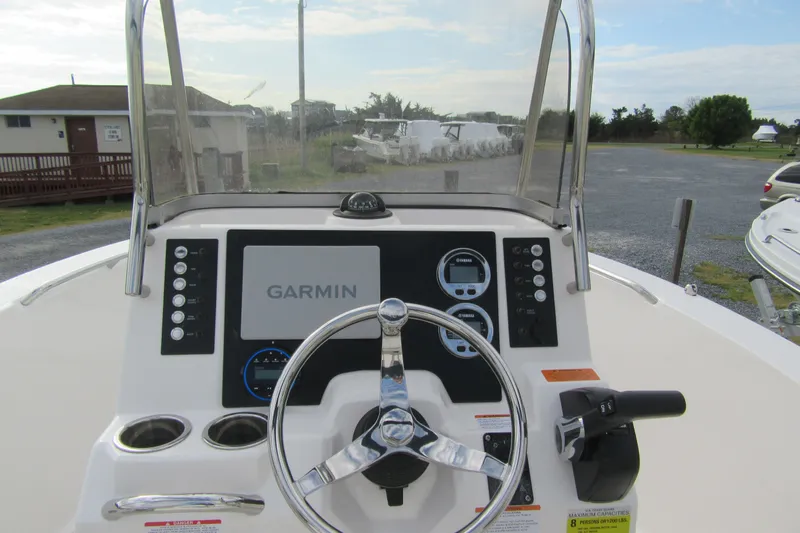 Slide: The Image of 2026 Robalo R180 Center Console boat dashboard with Garmin navigation system. - 3