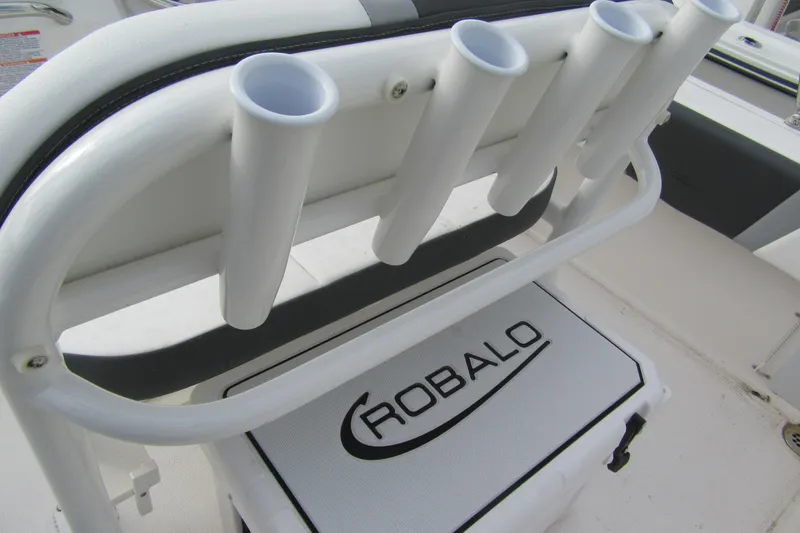 Slide: The Image of 2026 Robalo R180 Center Console boat with rod holders and branded cooler. - 4