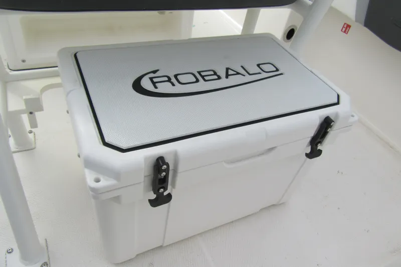 Slide: The Image of Robalo R180 Center Console 2026 boat cooler with secure latches and branded lid. - 7
