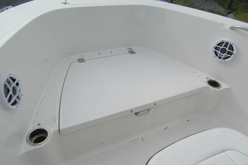Slide: The Image of 2026 Robalo R180 Center Console boat interior with storage compartment and speakers. - 8