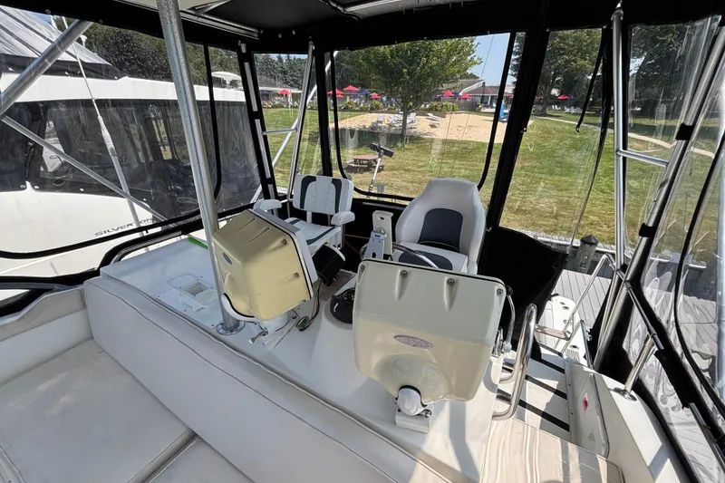 Slide: The Image of 1998 Bertram 33 Convertible Sport Fisherman cockpit with seating and controls. - 10