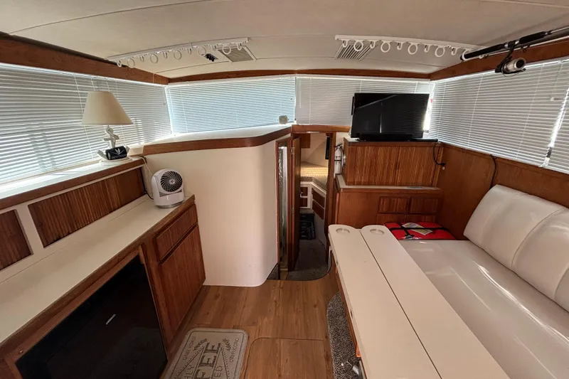 Slide: The Image of Interior of 1998 Bertram 33 Convertible Sport Fisherman with wood accents and modern amenities. - 5