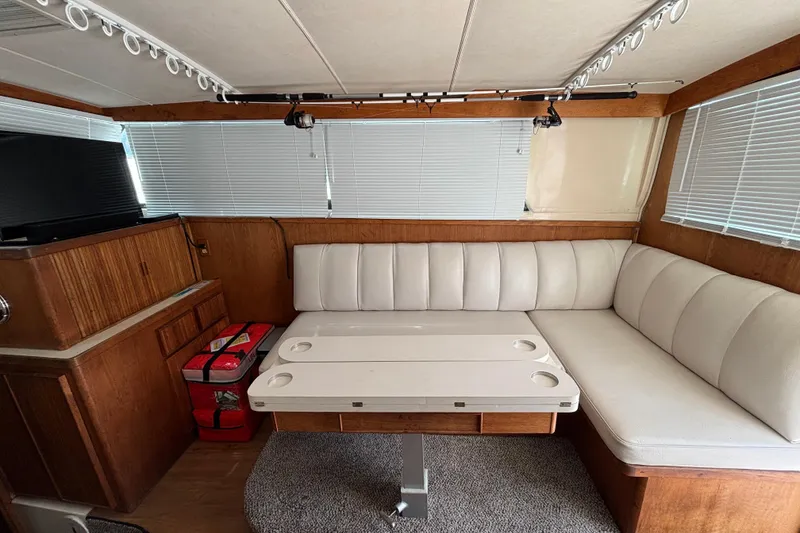 Slide: The Image of Interior of 1998 Bertram 33 Convertible Sport Fisherman with white seating and wooden accents. - 7