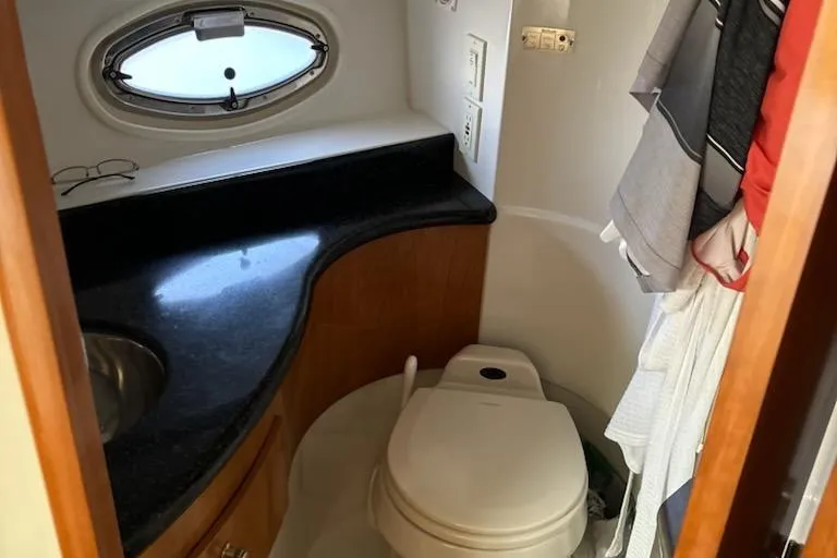 Slide: The Image of Bathroom interior of 2002 Carver 410 Sport Sedan with compact design and porthole window. - 10