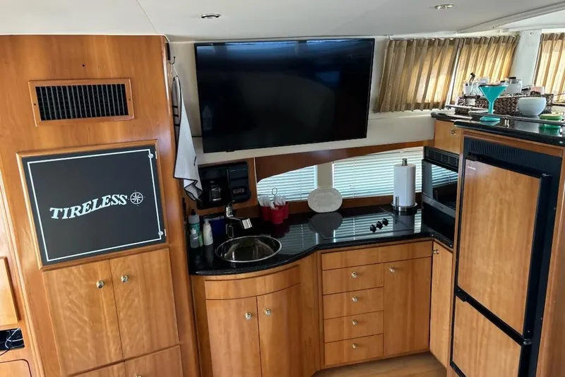 Slide: The Image of Interior of 2002 Carver 410 Sport Sedan yacht with wood cabinetry and modern amenities. - 3