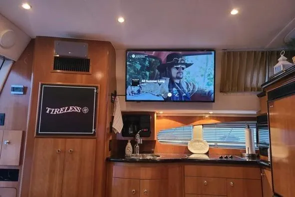 Slide: The Image of Interior of 2002 Carver 410 Sport Sedan with TV and kitchenette. - 4