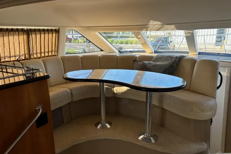 Slide: The Image of Interior of 2002 Carver 410 Sport Sedan with curved seating and table. - 6