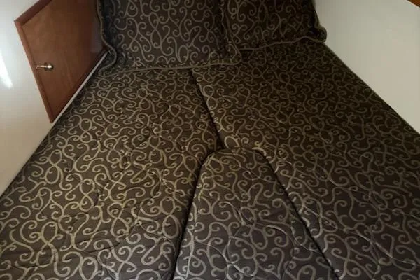 Slide: The Image of Luxurious bedding in a 2002 Carver 410 Sport Sedan cabin. - 9