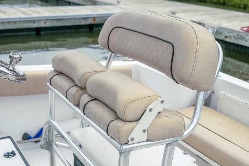 Slide: The Image of 2019 Sportsman Open 212 Center Console boat seat with beige cushions and metal frame. - 11