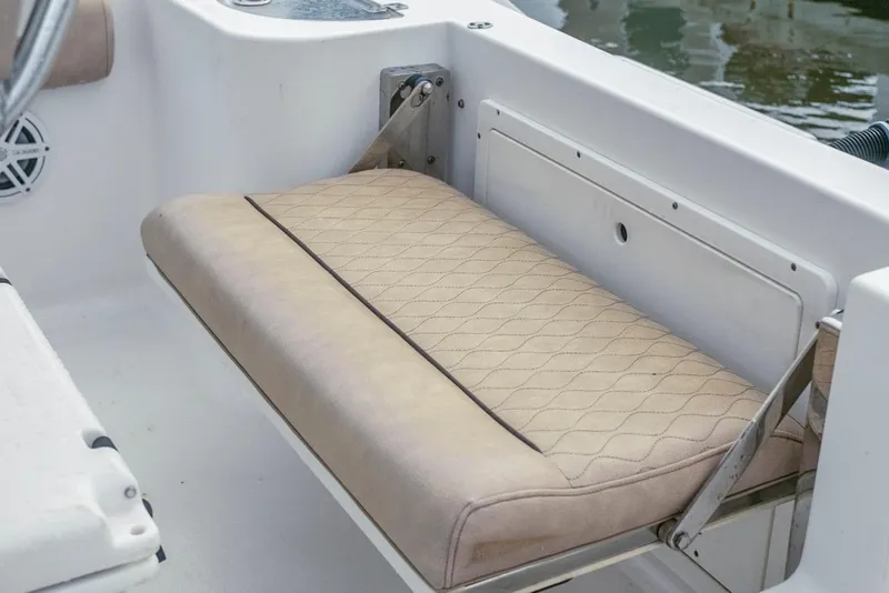 Slide: The Image of 2019 Sportsman Open 212 Center Console boat seat with beige upholstery and diamond stitching. - 14