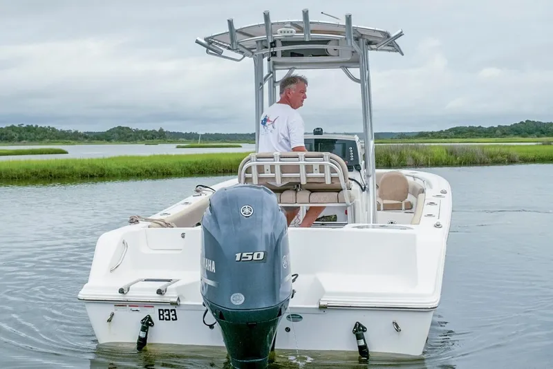 Slide: The Image of 2019 Sportsman Open 212 Center Console boat on calm water with Yamaha 150 engine. - 3