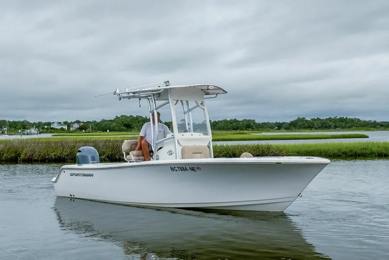 Slide: The Image of 2019 Sportsman Open 212 Center Console boat on calm water, overcast sky. - 7