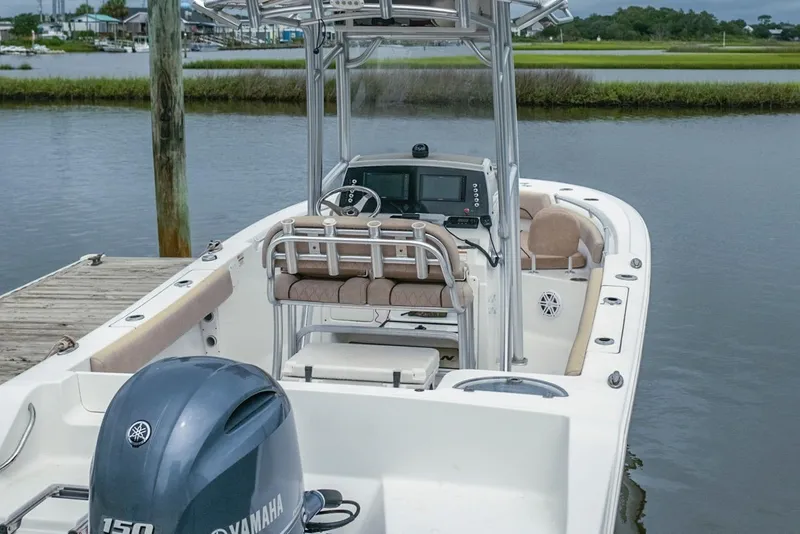 Slide: The Image of 2019 Sportsman Open 212 Center Console boat docked by the water. - 8