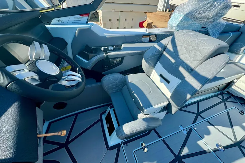 Slide: The Image of 2026 Nautique Super Air Nautique G23 Paragon cockpit with luxury seating and modern steering wheel. - 13