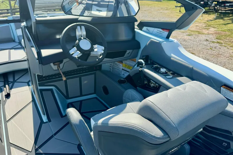 Slide: The Image of 2026 Nautique Super Air Nautique G23 Paragon cockpit with modern steering and controls. - 18