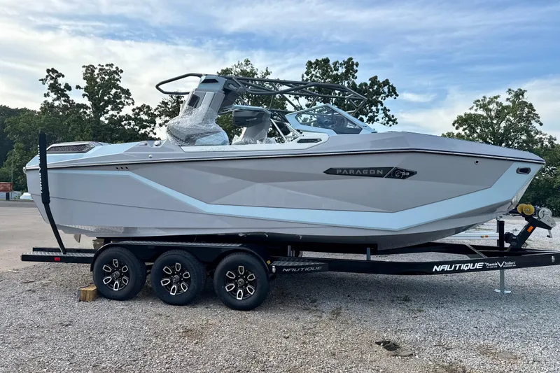 Slide: The Image of 2026 Nautique Super Air Nautique G23 Paragon boat on trailer, parked outdoors. - 9