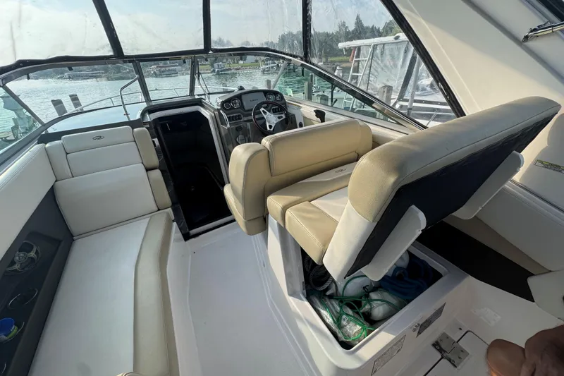 Slide: The Image of Interior of a 2012 Regal 28 Express boat with beige seating and steering console. - 10