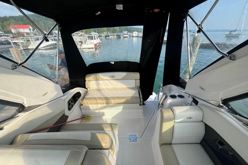 Slide: The Image of 2012 Regal 28 Express boat interior with seating, docked at marina. - 11