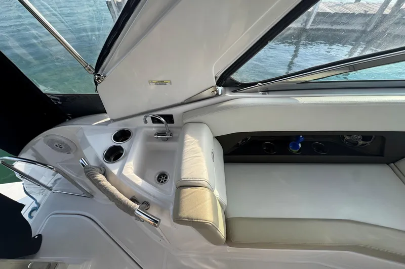 Slide: The Image of 2012 Regal 28 Express boat interior with seating, sink, and cup holders. - 12