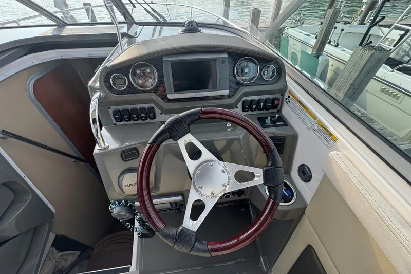 Slide: The Image of Steering console of a 2012 Regal 28 Express boat with gauges and controls. - 13