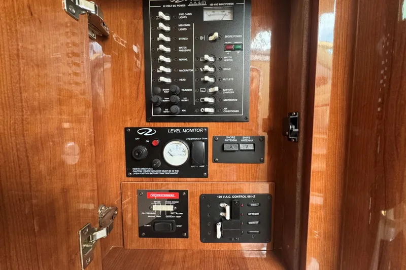 Slide: The Image of Control panel of a 2012 Regal 28 Express boat with switches and gauges. - 16