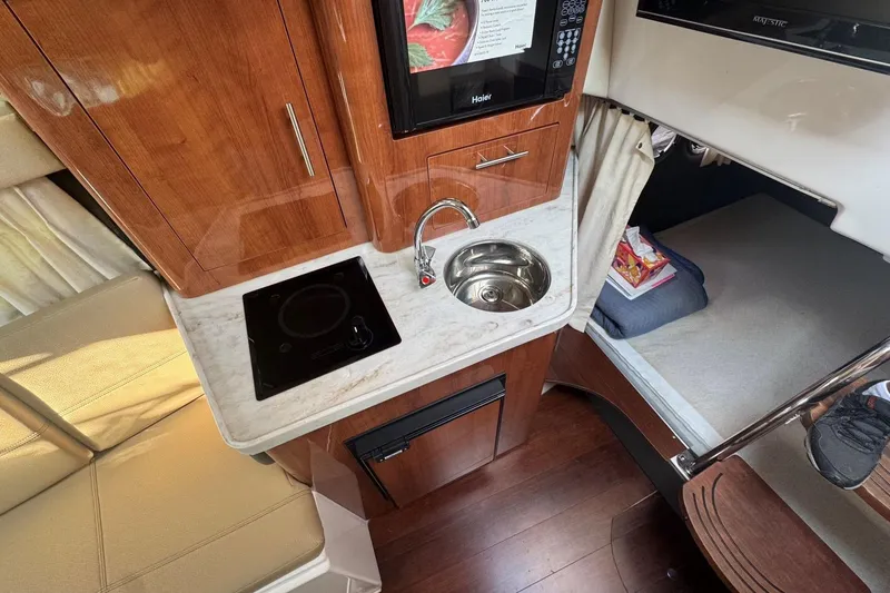 Slide: The Image of Interior of 2012 Regal 28 Express boat with kitchenette and sleeping area. - 18