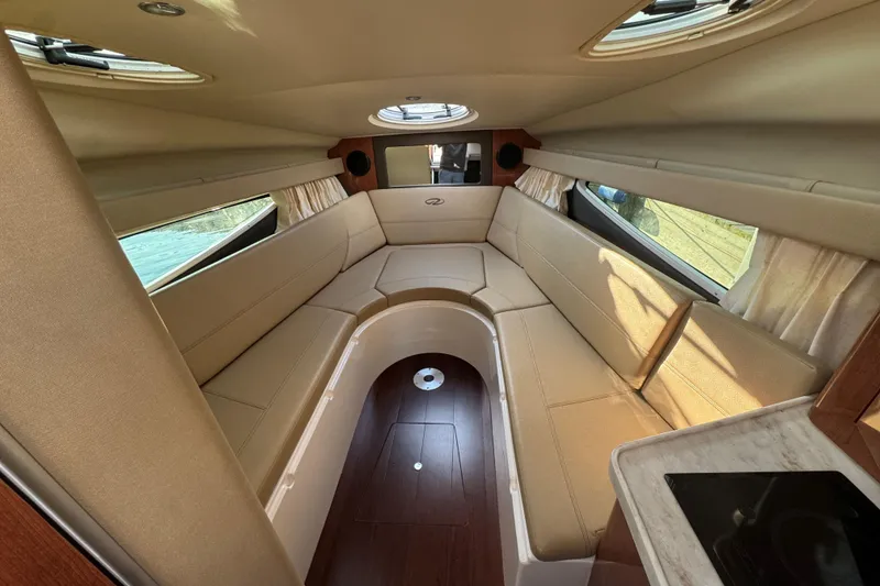 Slide: The Image of Luxurious interior of a 2012 Regal 28 Express boat with beige seating and wood accents. - 21