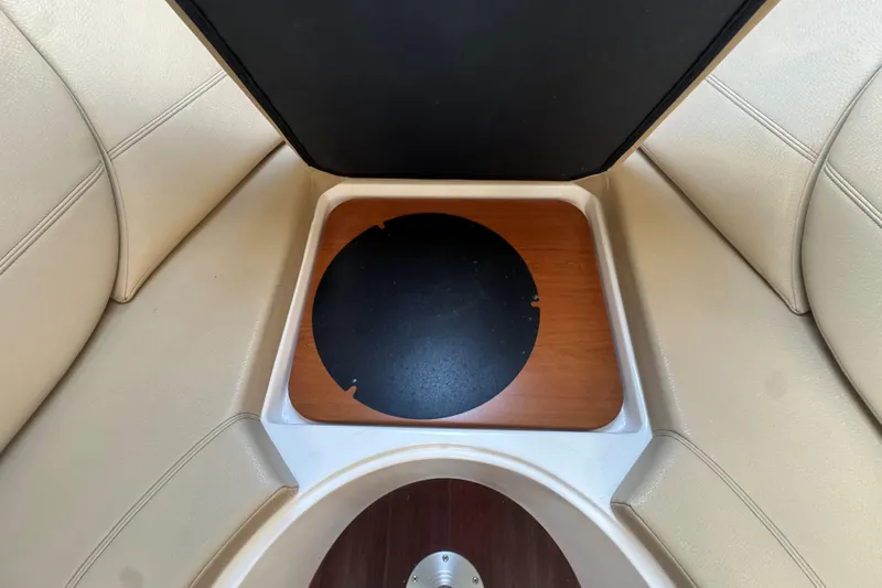 Slide: The Image of Interior view of a 2012 Regal 28 Express boat with seating and storage compartment. - 24