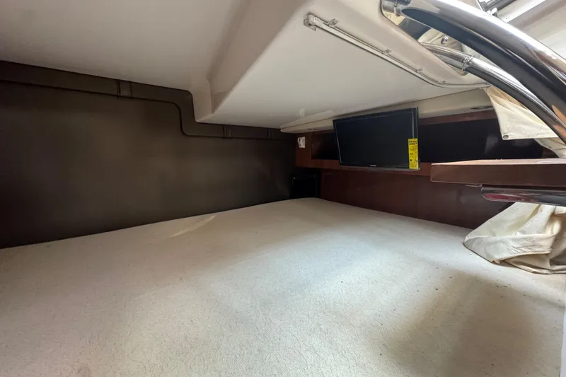 Slide: The Image of 2012 Regal 28 Express cabin interior with TV and cozy sleeping area. - 26