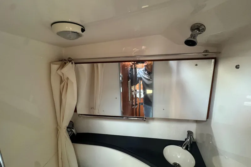 Slide: The Image of 2012 Regal 28 Express bathroom with mirror, sink, and showerhead. - 27
