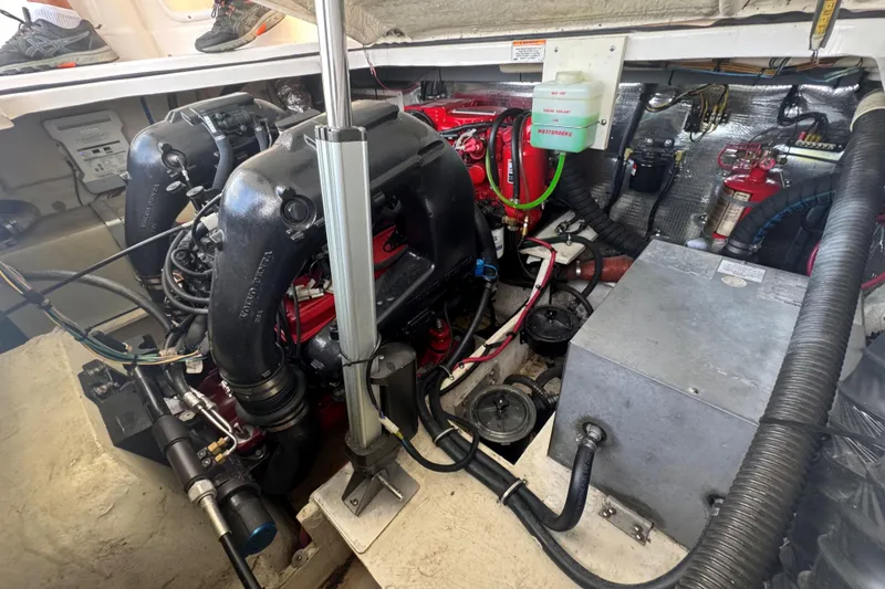 Slide: The Image of Engine compartment of a 2012 Regal 28 Express boat, showcasing mechanical components and wiring. - 30