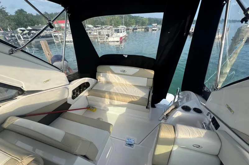 Slide: The Image of 2012 Regal 28 Express boat interior with seating, docked at a marina. - 9