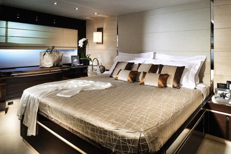 Slide: The Image of Luxurious bedroom interior of 2014 Sunseeker Predator 68 yacht, featuring elegant decor and plush bedding. - 10