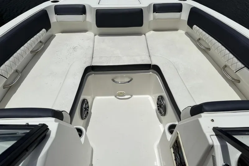 Slide: The Image of Interior seating area of a 2020 Bayliner DX2200 boat, featuring cushioned seats and cup holders. - 14