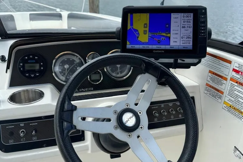 Slide: The Image of Bayliner DX2200 2020 dashboard with steering wheel and Garmin navigation system. - 15