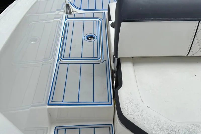 Slide: The Image of Bayliner DX2200 2020 boat interior with blue-striped deck and cushioned seating. - 16