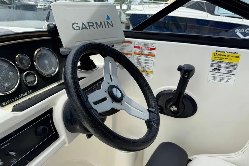 Slide: The Image of Steering wheel and controls of 2020 Bayliner DX2200 boat with Garmin navigation system. - 18