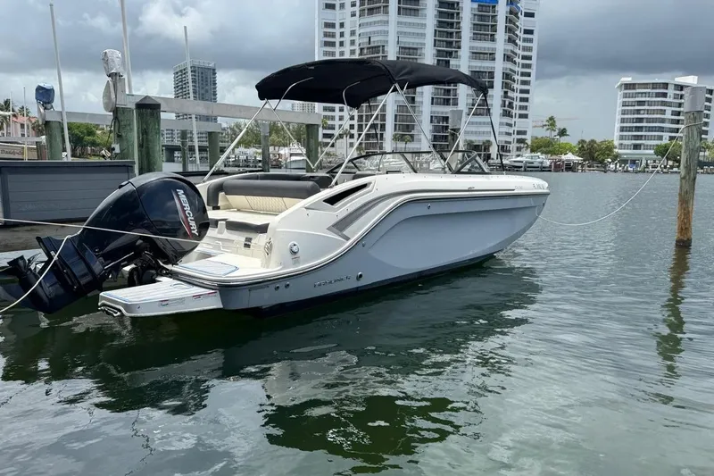 Slide: The Image of 2020 Bayliner DX2200 boat docked in marina with Mercury outboard motor. - 21