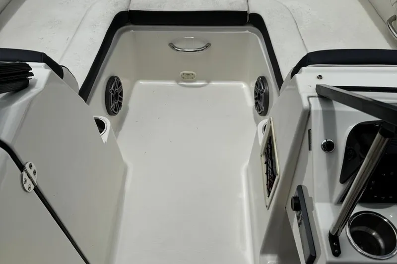 Slide: The Image of 2020 Bayliner DX2200 boat interior with speakers and cup holders. - 5