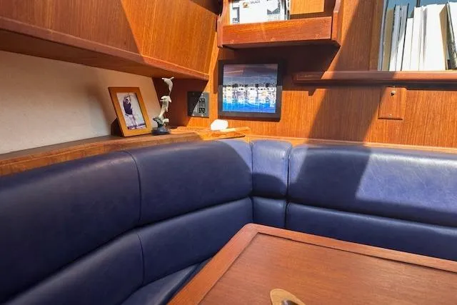 Slide: The Image of 1988 Viking 45 Convertible yacht interior with blue leather seating and wooden accents. - 13