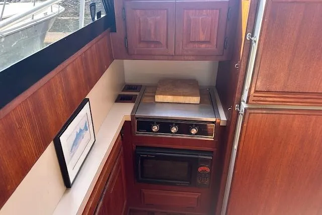 Slide: The Image of 1988 Viking 45 Convertible yacht kitchen with wooden cabinets and modern appliances. - 16