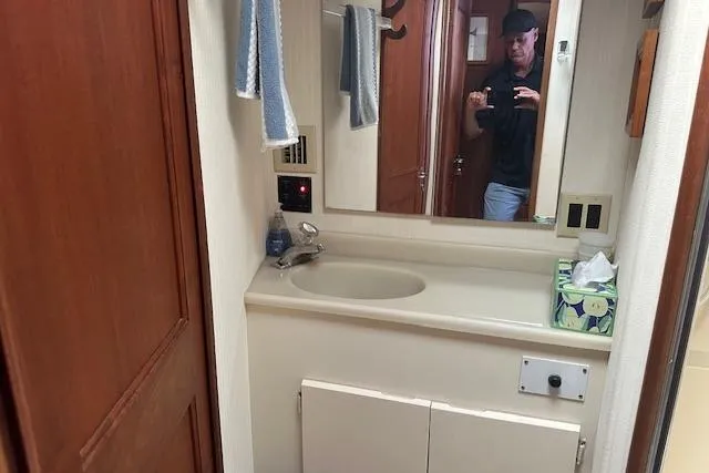 Slide: The Image of Bathroom interior of a 1988 Viking 45 Convertible yacht with sink and mirror. - 19
