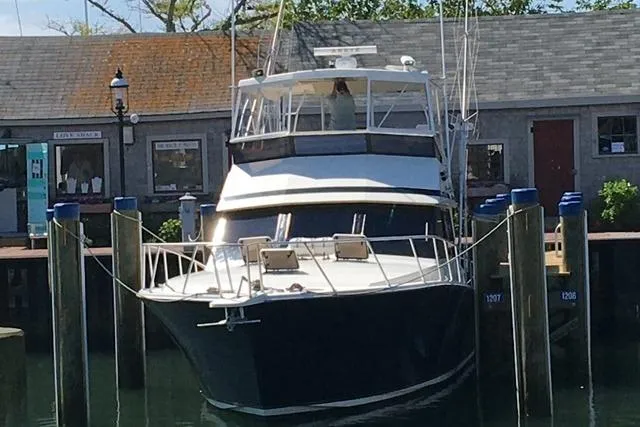 Slide: The Image of 1988 Viking 45 Convertible yacht docked at a marina, front view. - 2